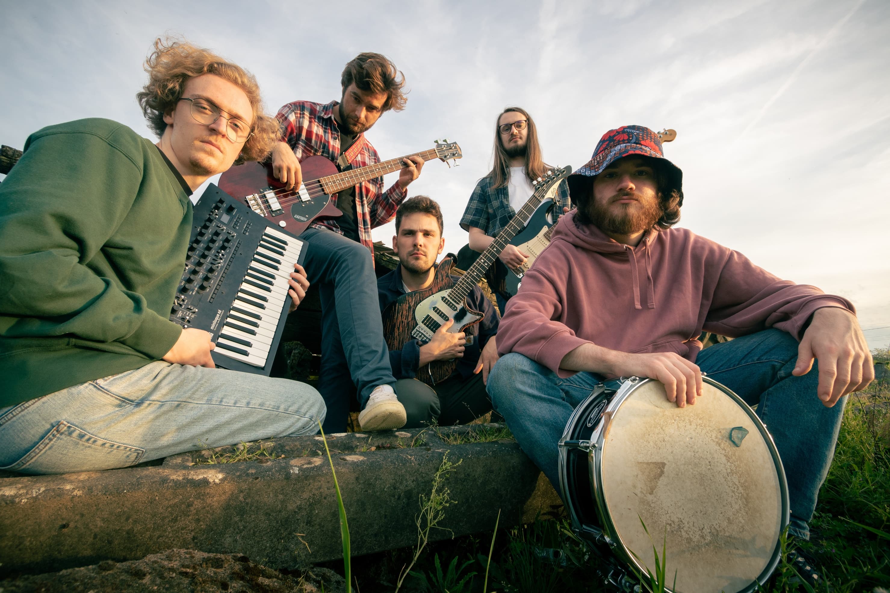 Stylish photograph of the group members standing on a rock looking at the camera